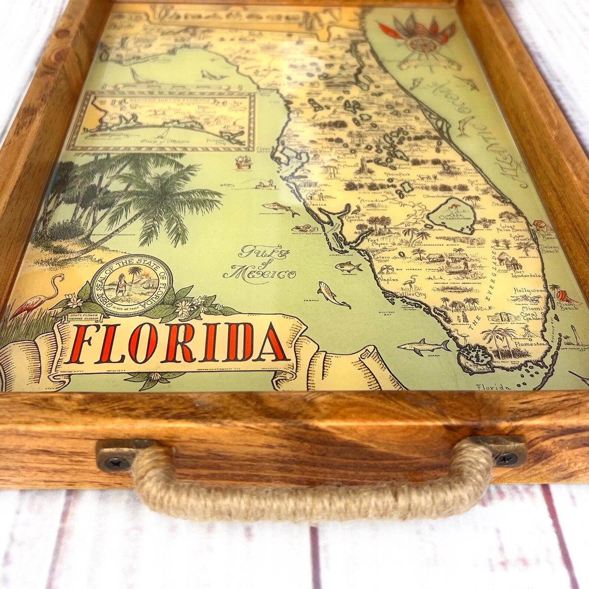 Map of Florida with decorative elements on a wooden surface and palm trees. vintage florida map