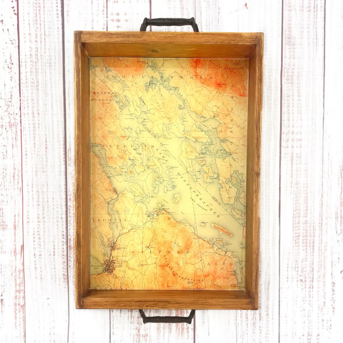 topographical map of lake winnipesaukee lake in new hampshire.  map of lake winnipesaukee in wooden tray with handles