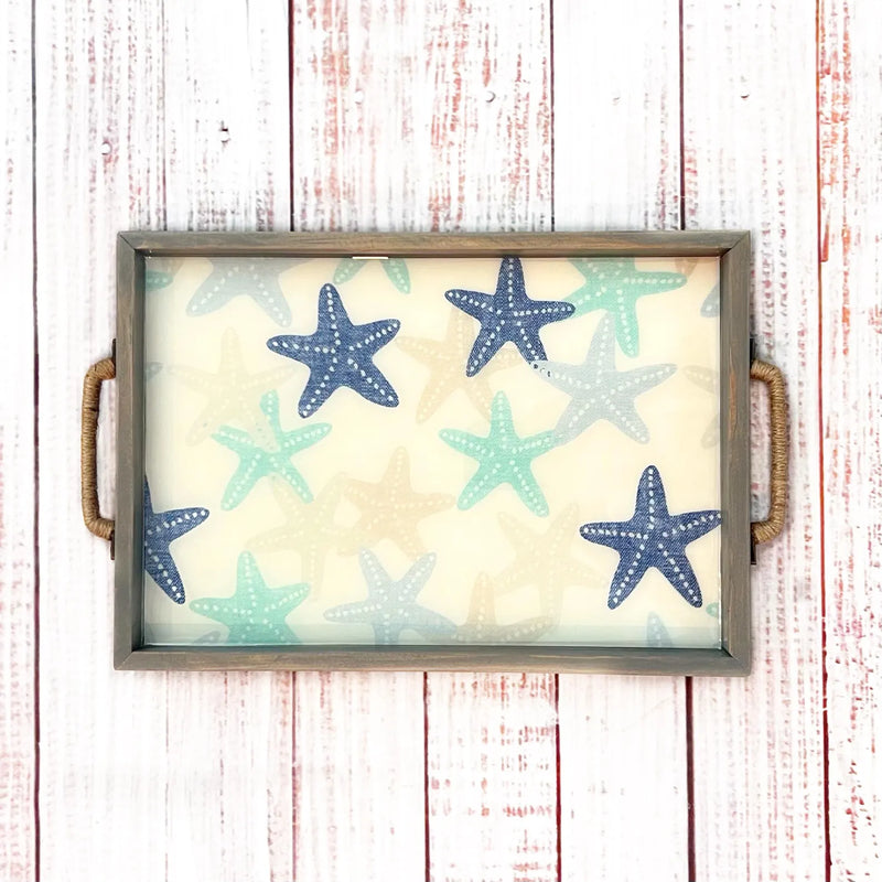 Decorative tray with starfish pattern on a wooden surface