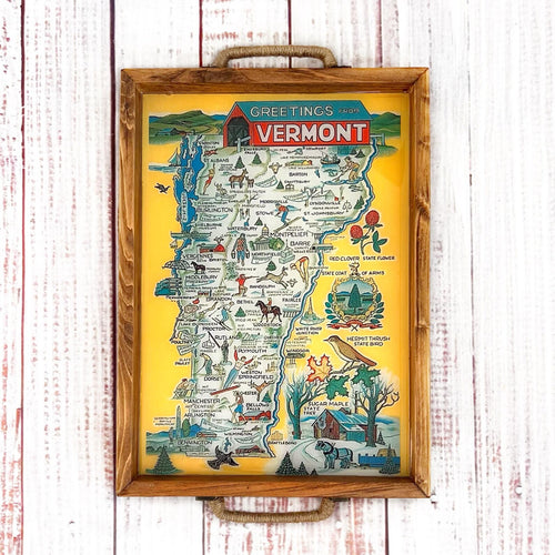 Framed map of Vermont with illustrations on a wooden surface. wood serving tray with vintage map of vermont with illustrations