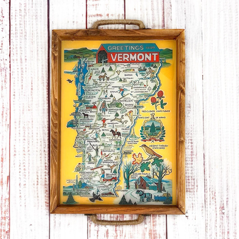 Framed map of Vermont with illustrations on a wooden surface. wood serving tray with vintage map of vermont with illustrations